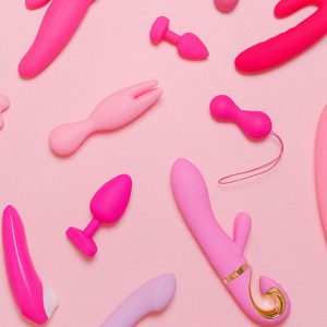 Explore a variety of pink adult toys including vibrators, silicone accessories, and more on a pastel background.